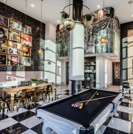 A pool table in a room with a checkered floor