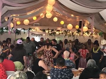 A large group of people are dancing in a room.