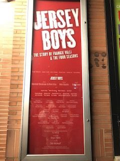 A red sign that says jersey boys on it