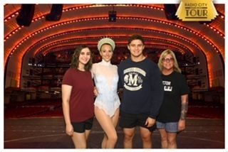 A group of people posing for a picture in front of a sign that says casino city tour