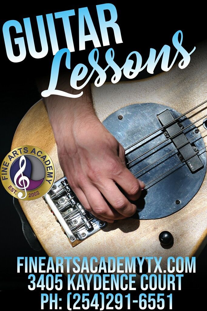 A poster for guitar lessons shows a person playing a guitar