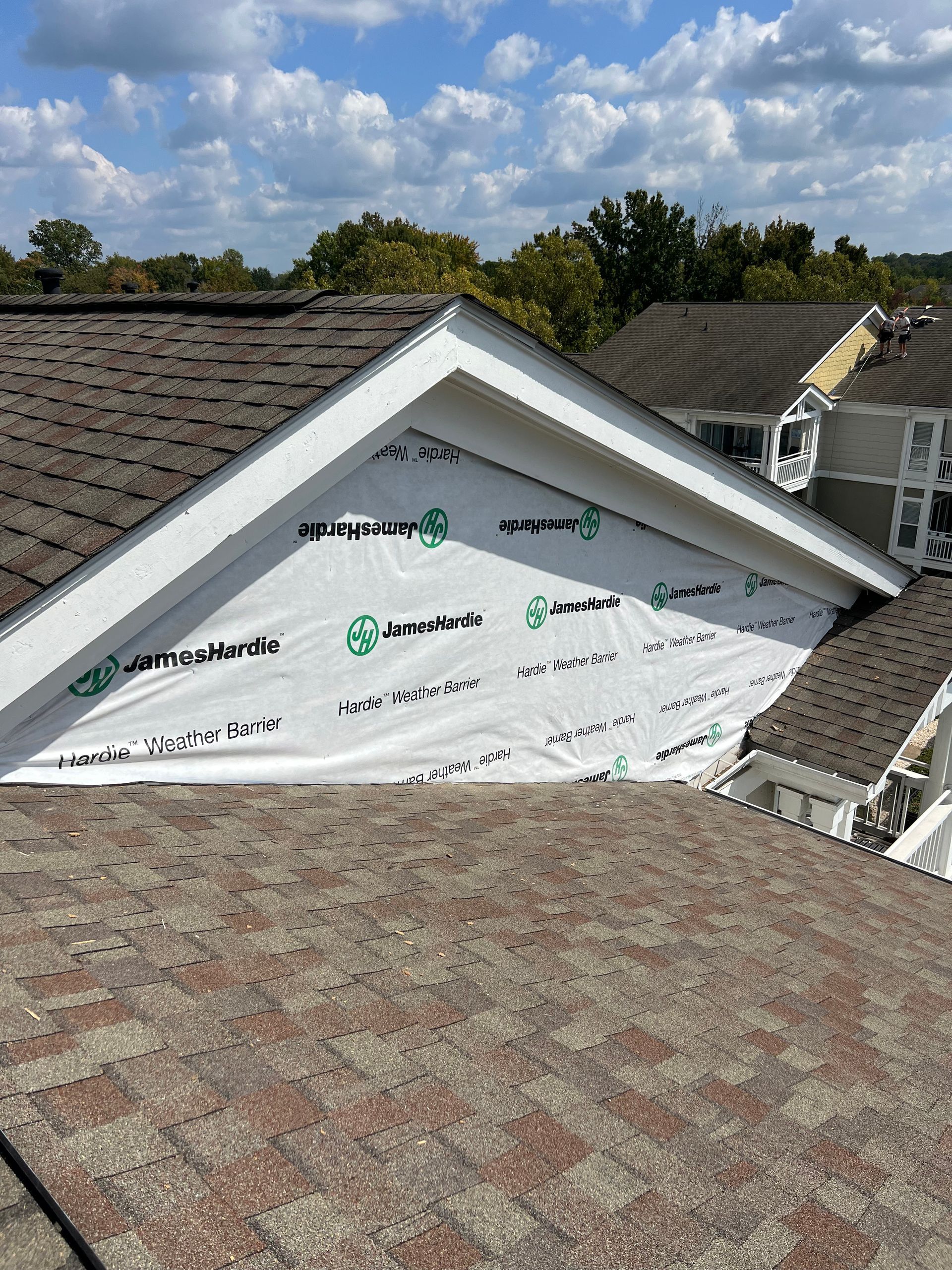 A roof with a triangle shaped roof and a white roof covering.