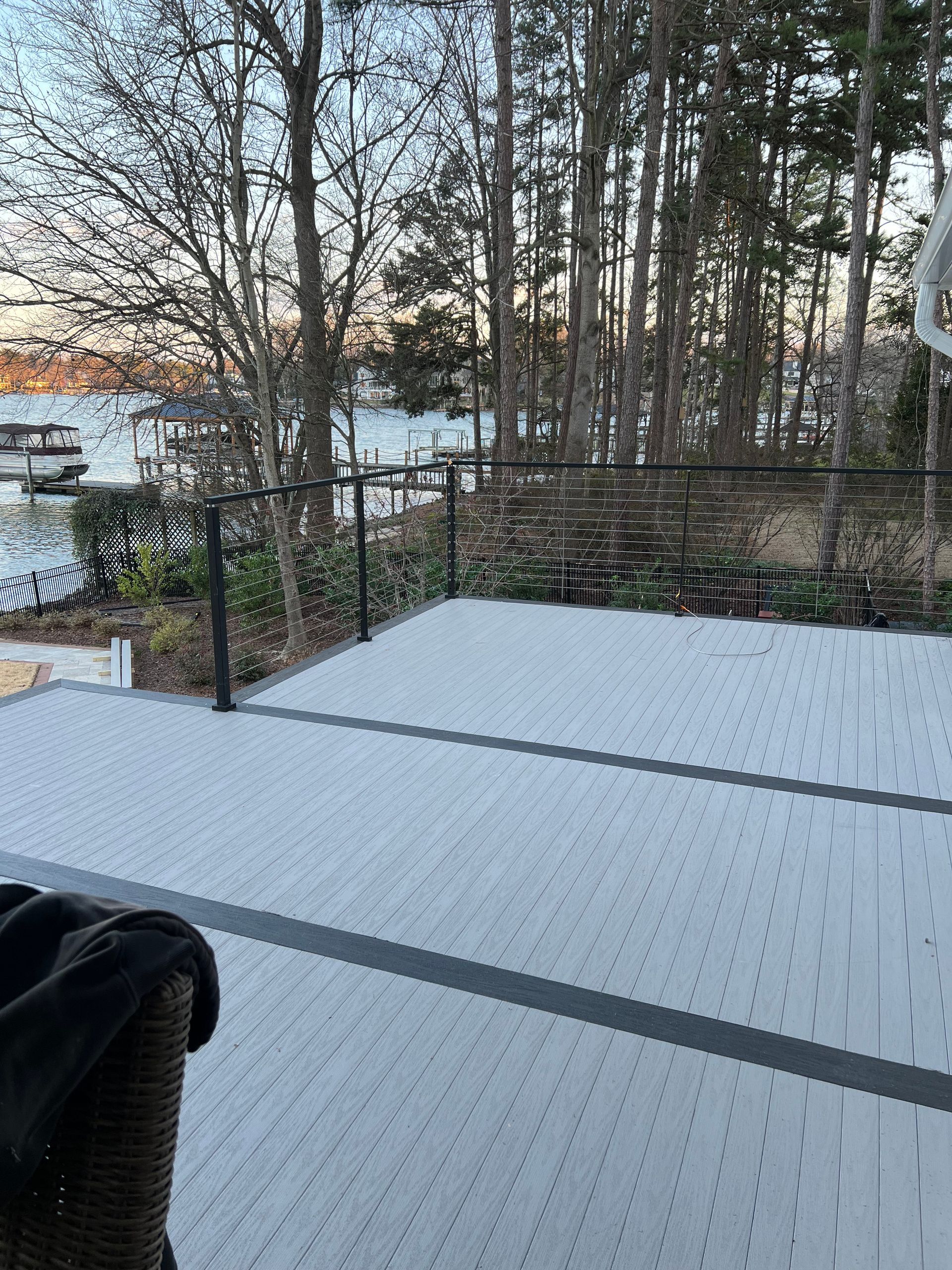 A deck with a view of a lake and trees