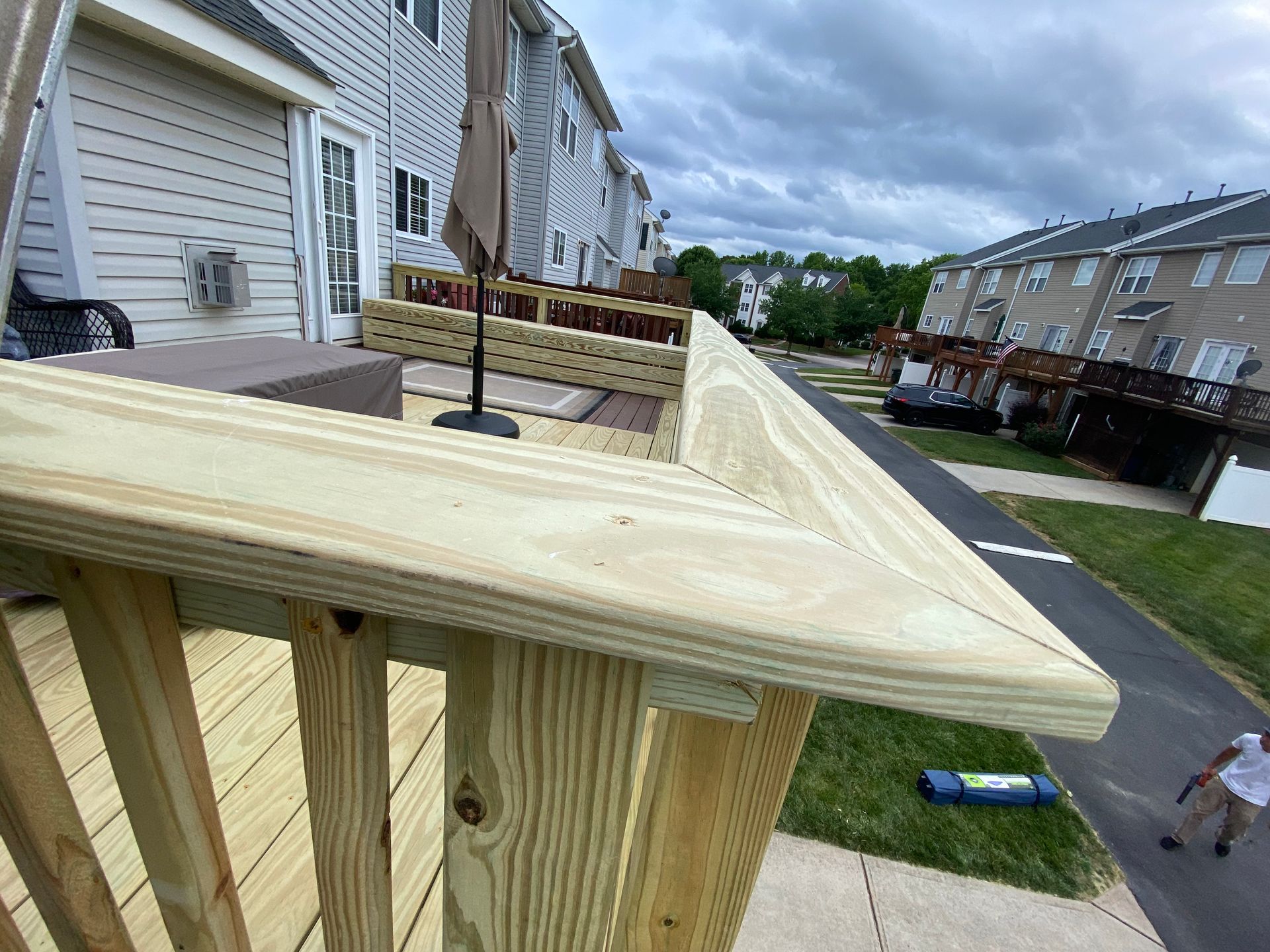 A wooden deck is being built in a residential neighborhood.