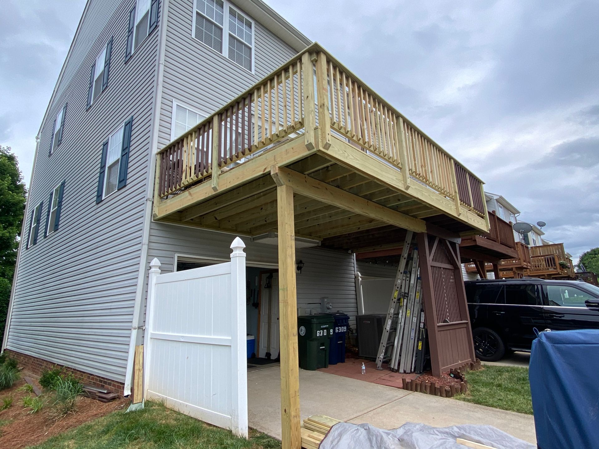 A wooden deck is being built on the side of a house.