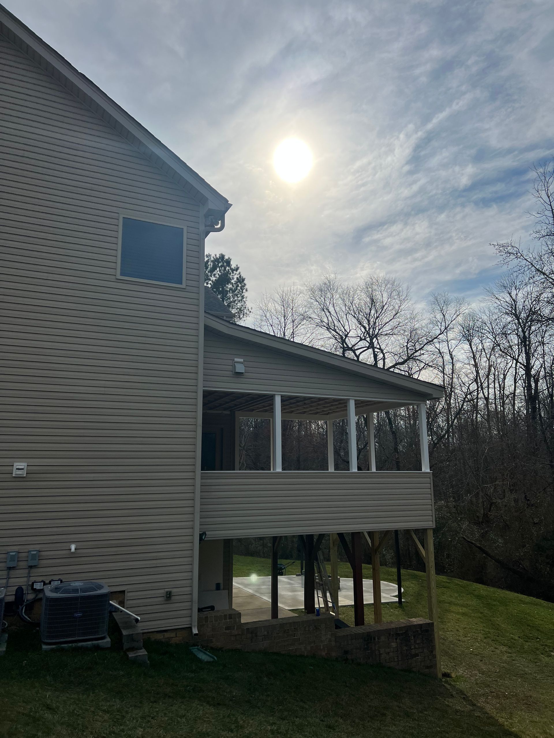 The sun is shining brightly on the side of a house