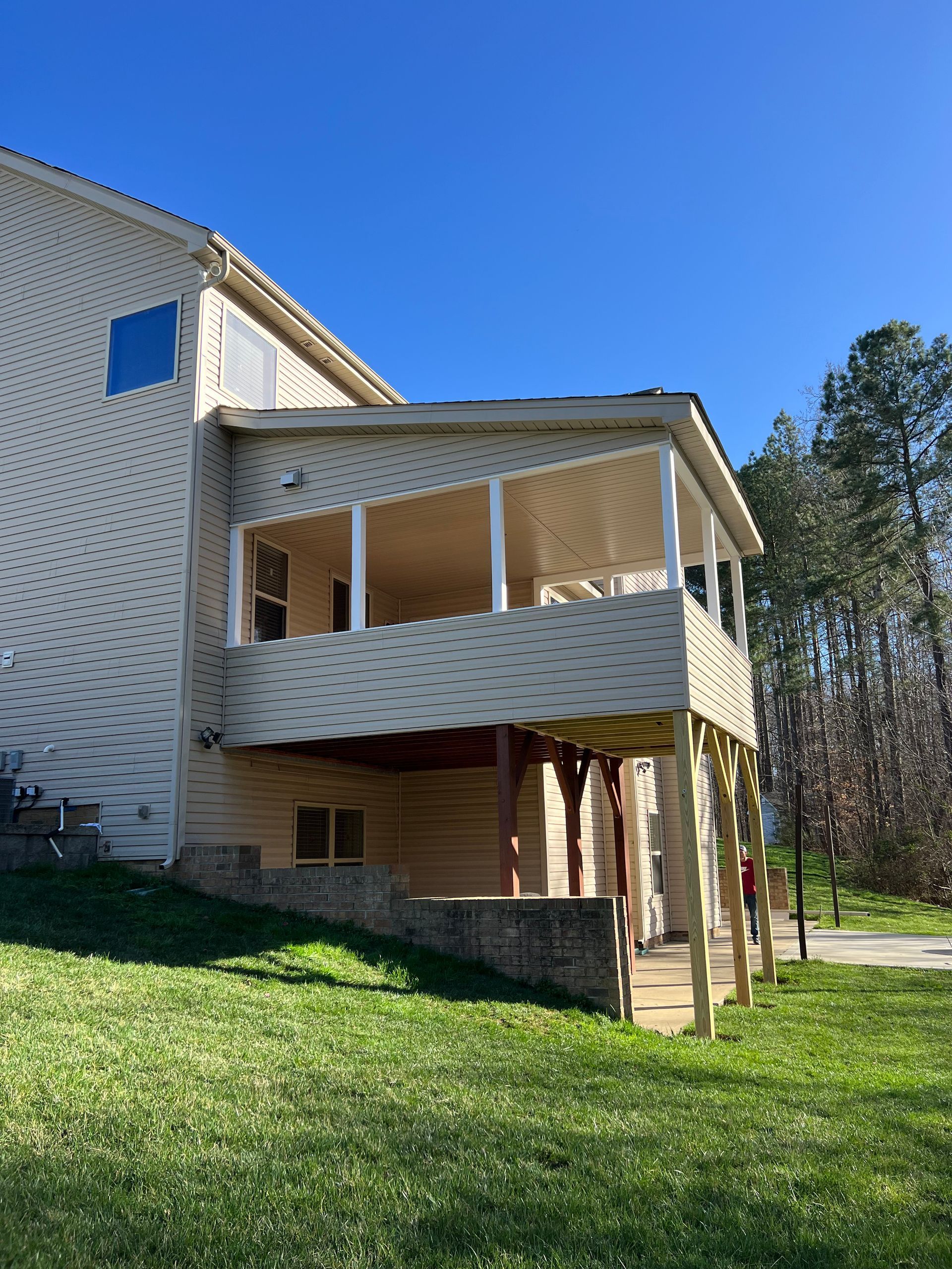 A large house with a large porch on the side of it.