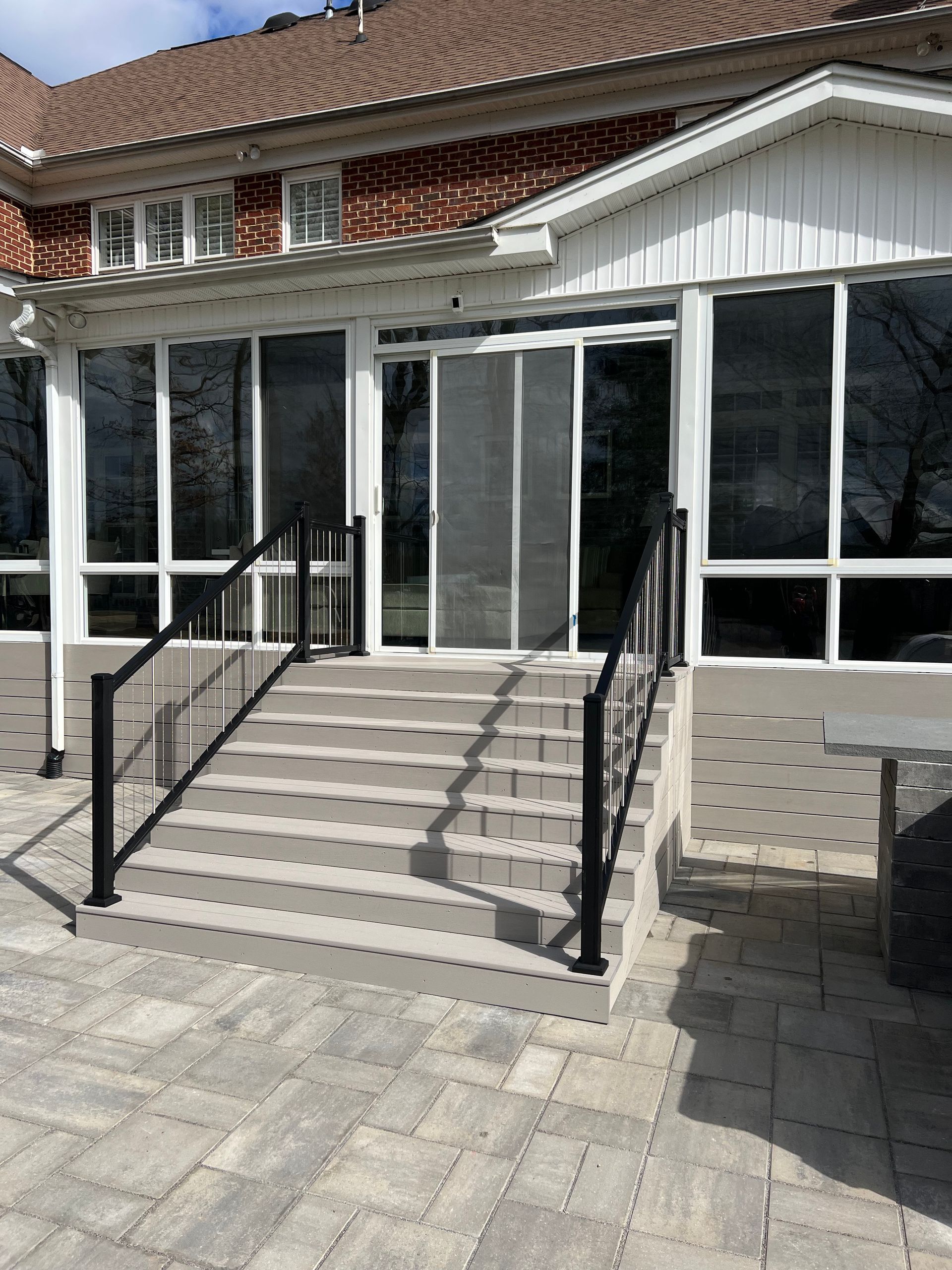 There are stairs leading up to the front of a building.