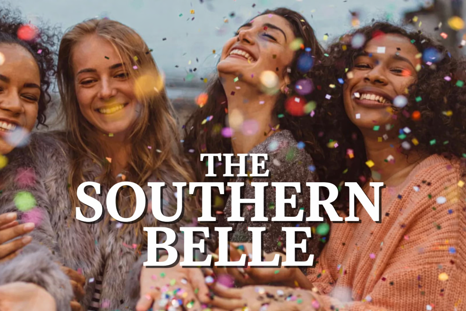 Elegant lobby with green chairs, fireplace, chandelier, and reception desk.