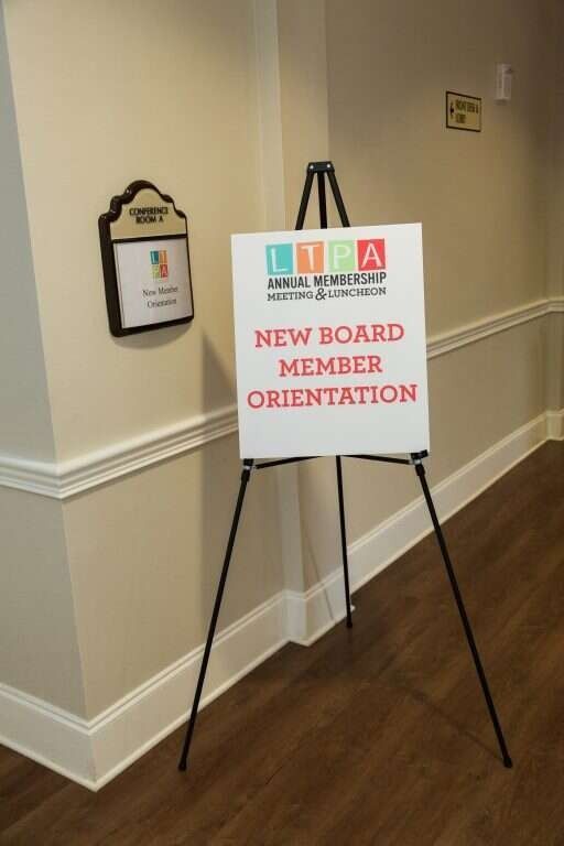 A sign on an easel indicates a New Board Member Orientation for LIPA in a hallway.
