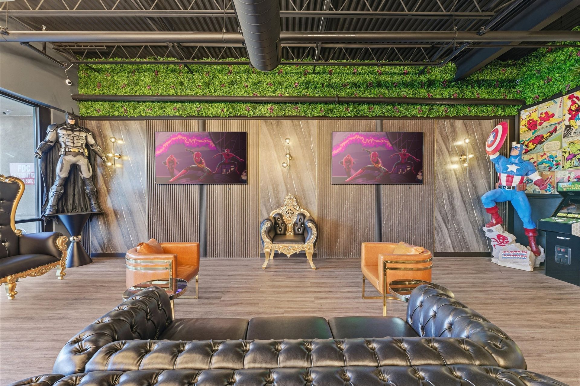 Lounge with superhero décor, tufted leather sofa, armchairs, golden throne, two screens, and Captain America statue. Adventure Smiles Dental and Orthodontics -Pasadena