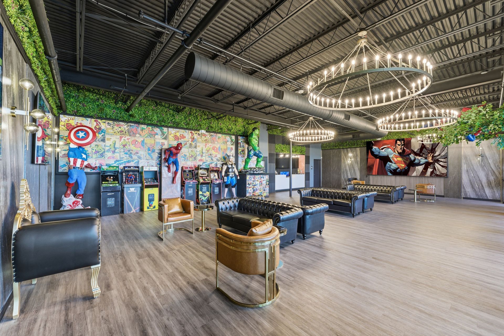 Game room with arcade games, couches, and superhero artwork. Adventure Smiles Dental and Orthodontics -Pasadena