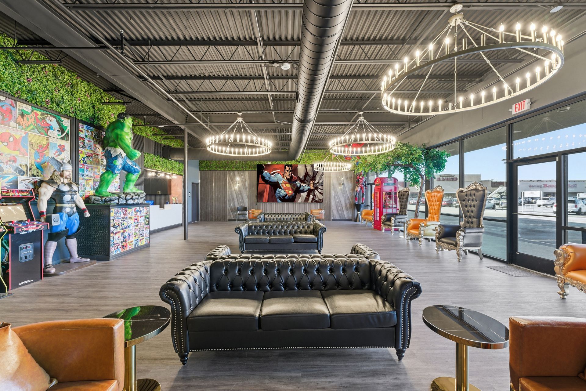 Spacious showroom with black leather sofas, decorative chandeliers, and colorful superhero-themed art. Adventure Smiles Dental and Orthodontics -Pasadena