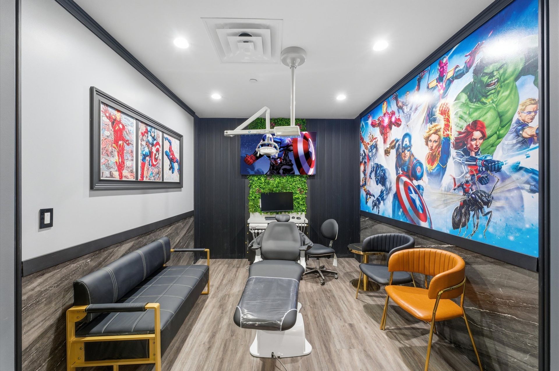 Superhero-themed dental room. Features include a dental chair, framed art, and a large wall mural with Marvel characters.  Adventure Smiles Dental and Orthodontics -Pasadena