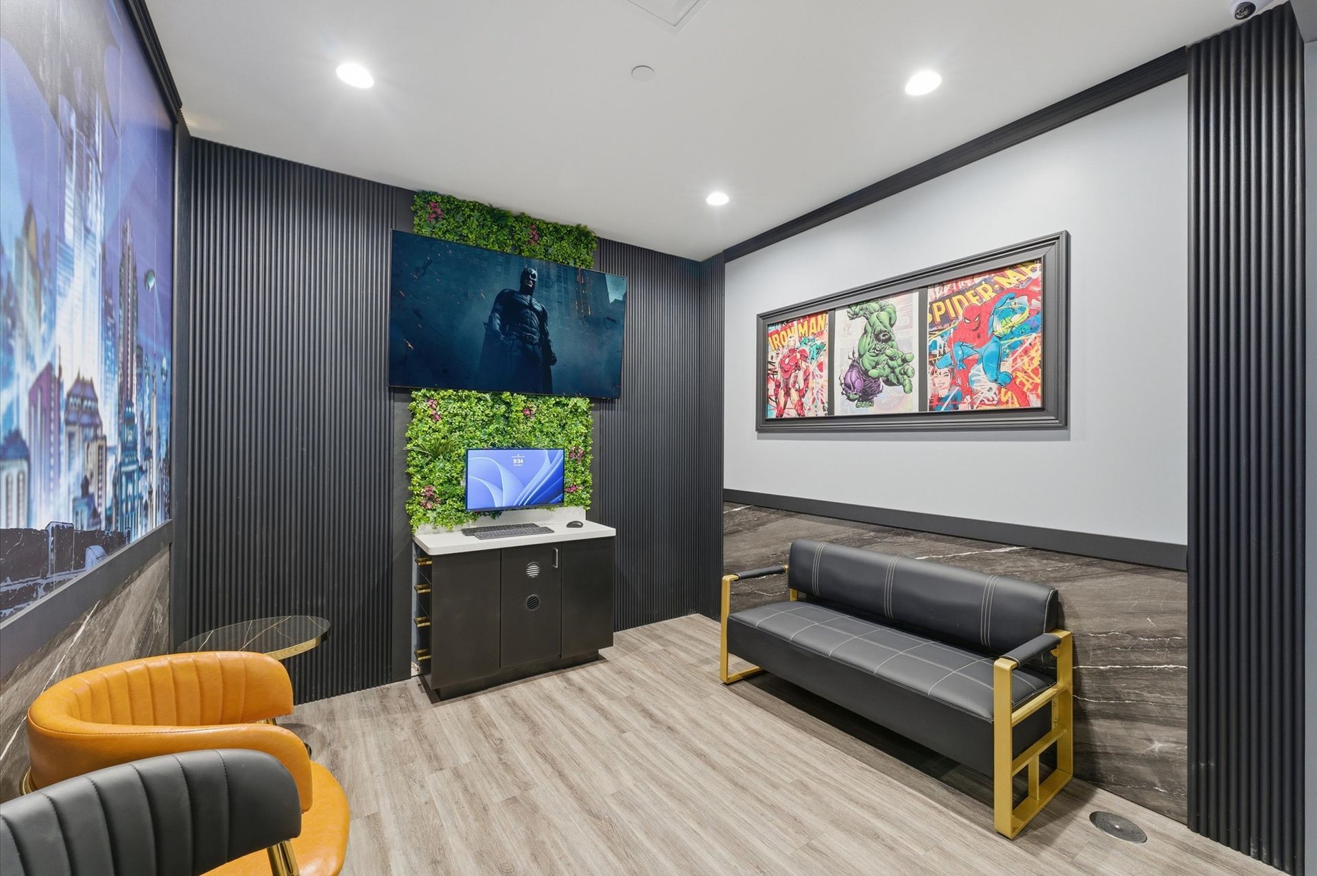 Gaming room with a TV, computer, couch, and artwork. Green and gray color scheme. Adventure Smiles Dental and Orthodontics -Pasadena