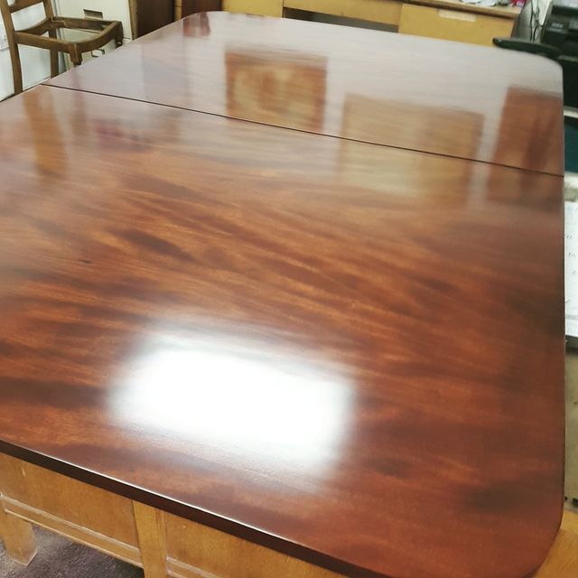 Polished wooden conference table with chairs around it in a meeting room