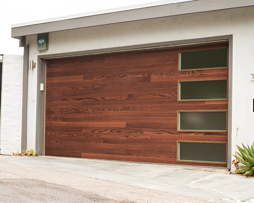 Modern garage door with dark wood finish and four frosted glass windows on the right side