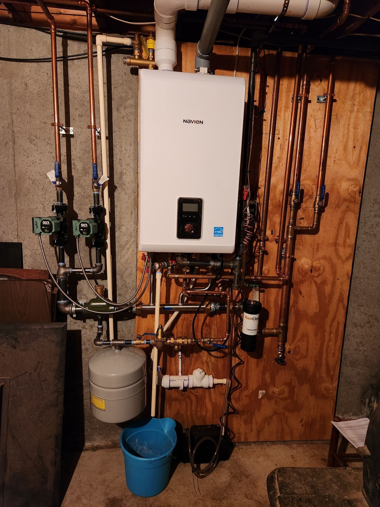 A newly installed Navien natural gas boiler system with copper piping