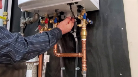 DiRocco Plumbing & Heating Services performs Navien repair inspection on heater system ensuring effi