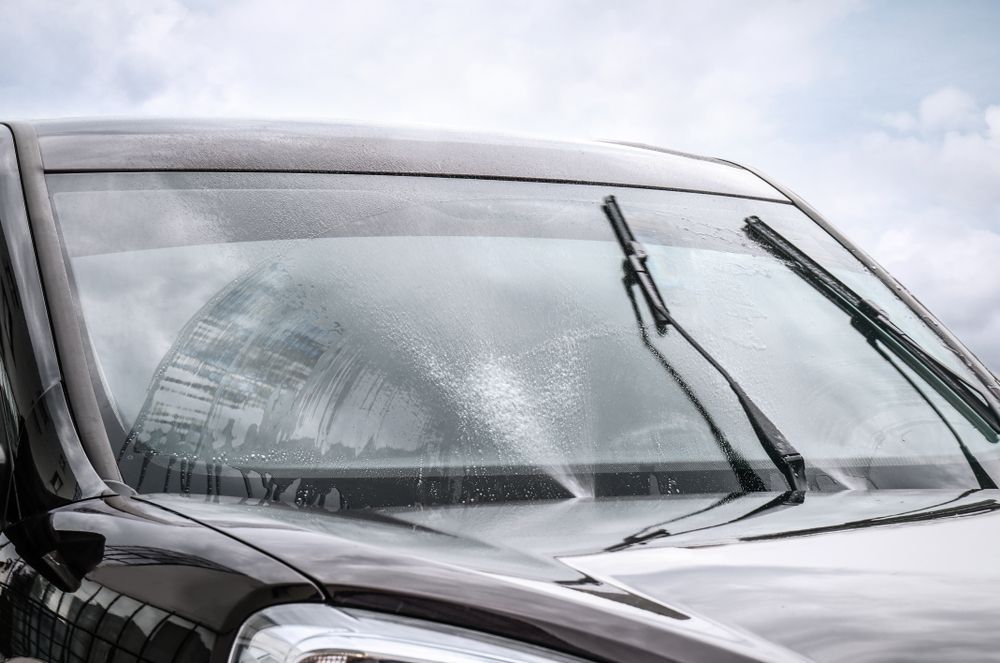 A Close Up of a Car Windshield With Wiper Blades — Crakka Windscreens in Nabiac, NSW