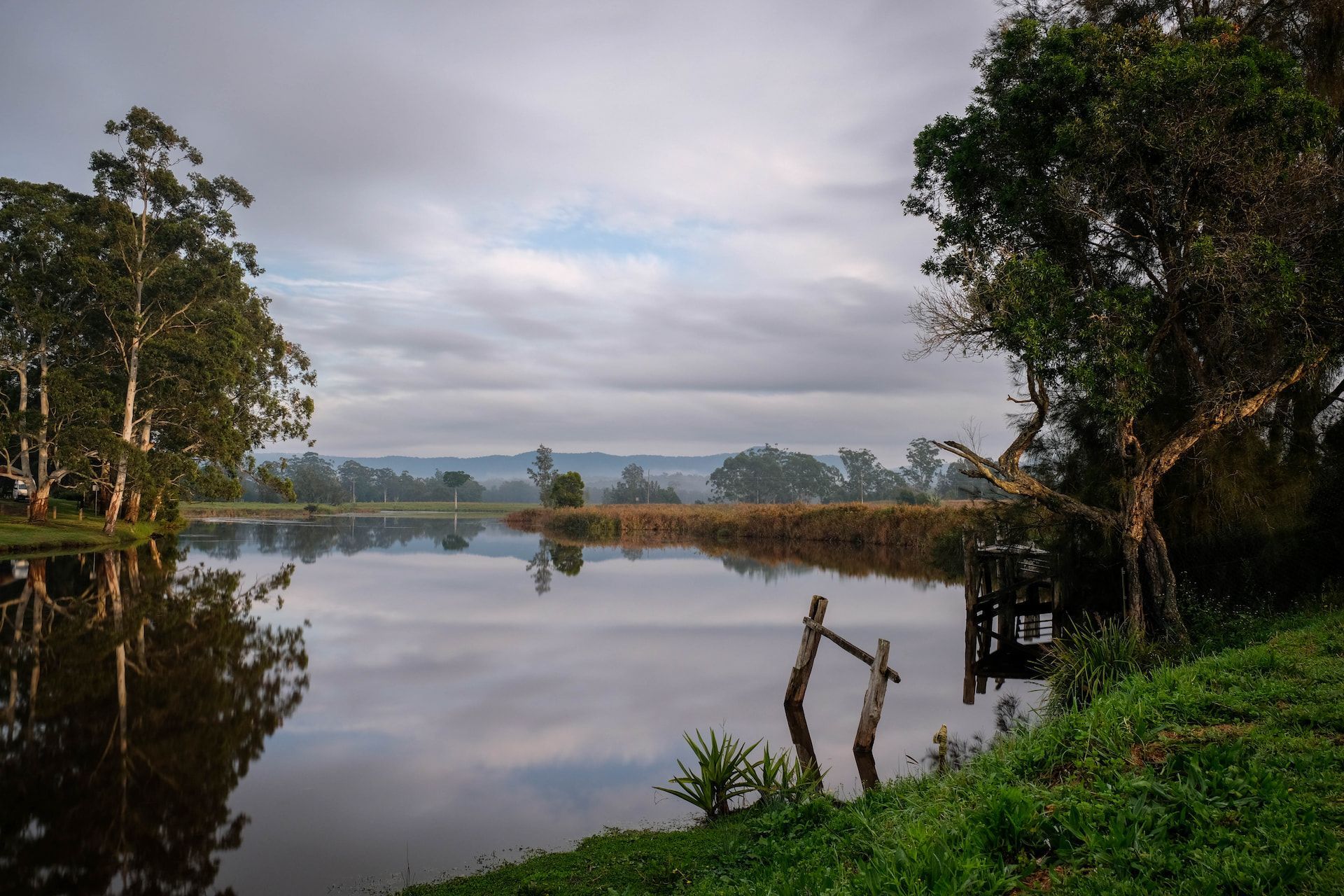A River Surrounded by Trees and Grass on a Cloudy Day — Crakka Windscreens in Bulahdelah, NSW