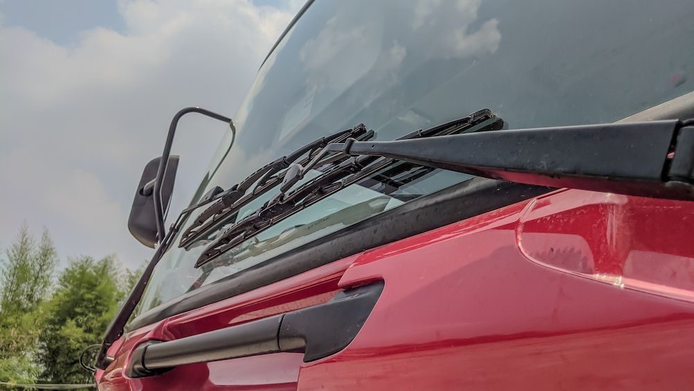 A Close Up of a Red Truck 's Windshield With Wiper Blades — Crakka Windscreens in Old Bar, NSW