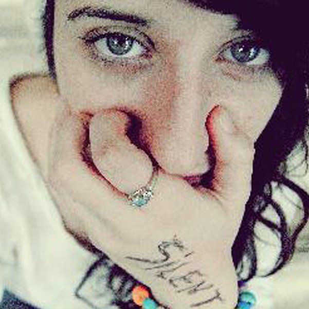 Young woman covering mouth