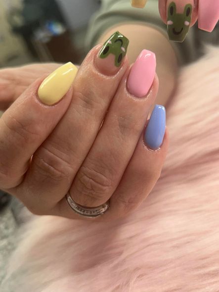 A close up of a person 's nails with a ring on their finger.