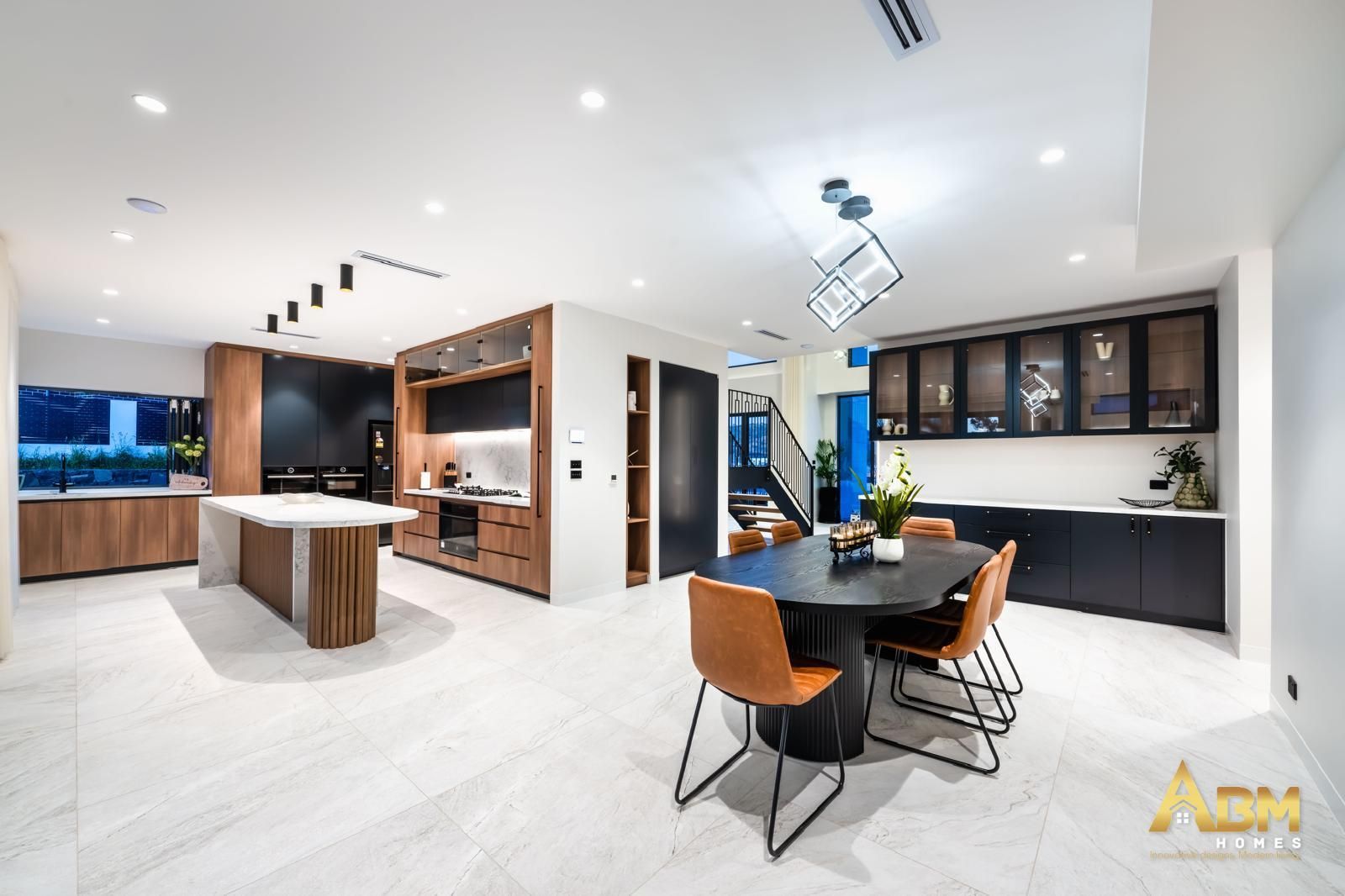 A Dining Room With Black Table And A Kitchen With Wood Cabinets — ASM Joinery In Fyshwick, ACT