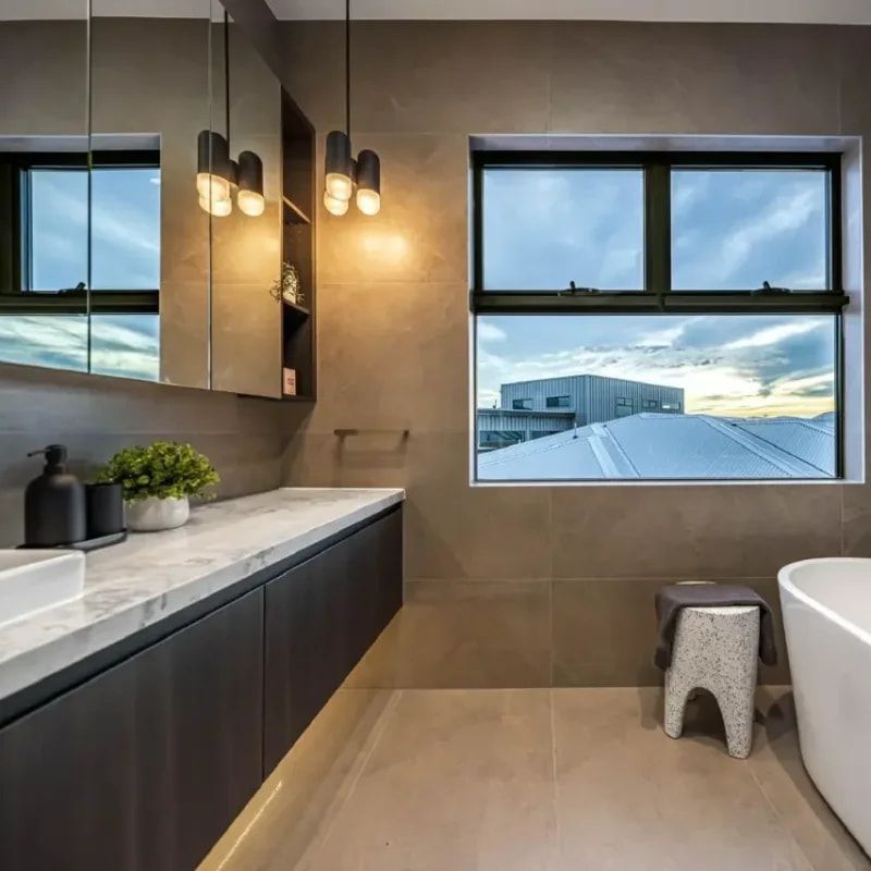 A Bathroom With A Tub, Sink, Mirror And Window — ASM Joinery In Fyshwick, ACT