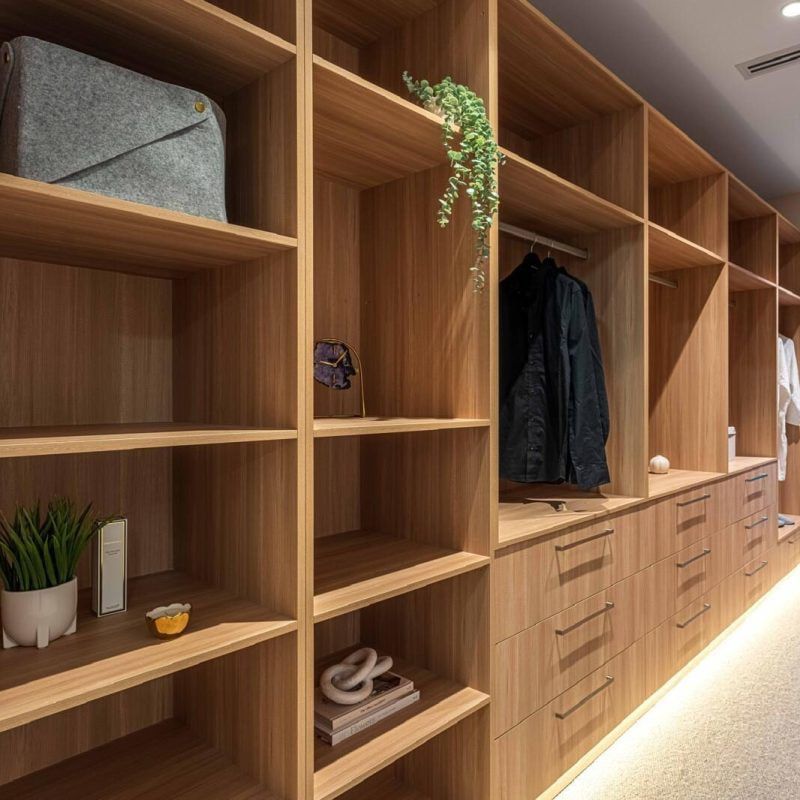 A Walk In Closet With Lots Of Wooden Shelves And Drawers — ASM Joinery In Fyshwick, ACT