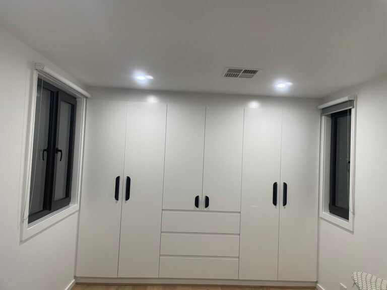 A Room With A Lot Of White Cabinets And Drawers And Two Windows — ASM Joinery In Fyshwick, ACT