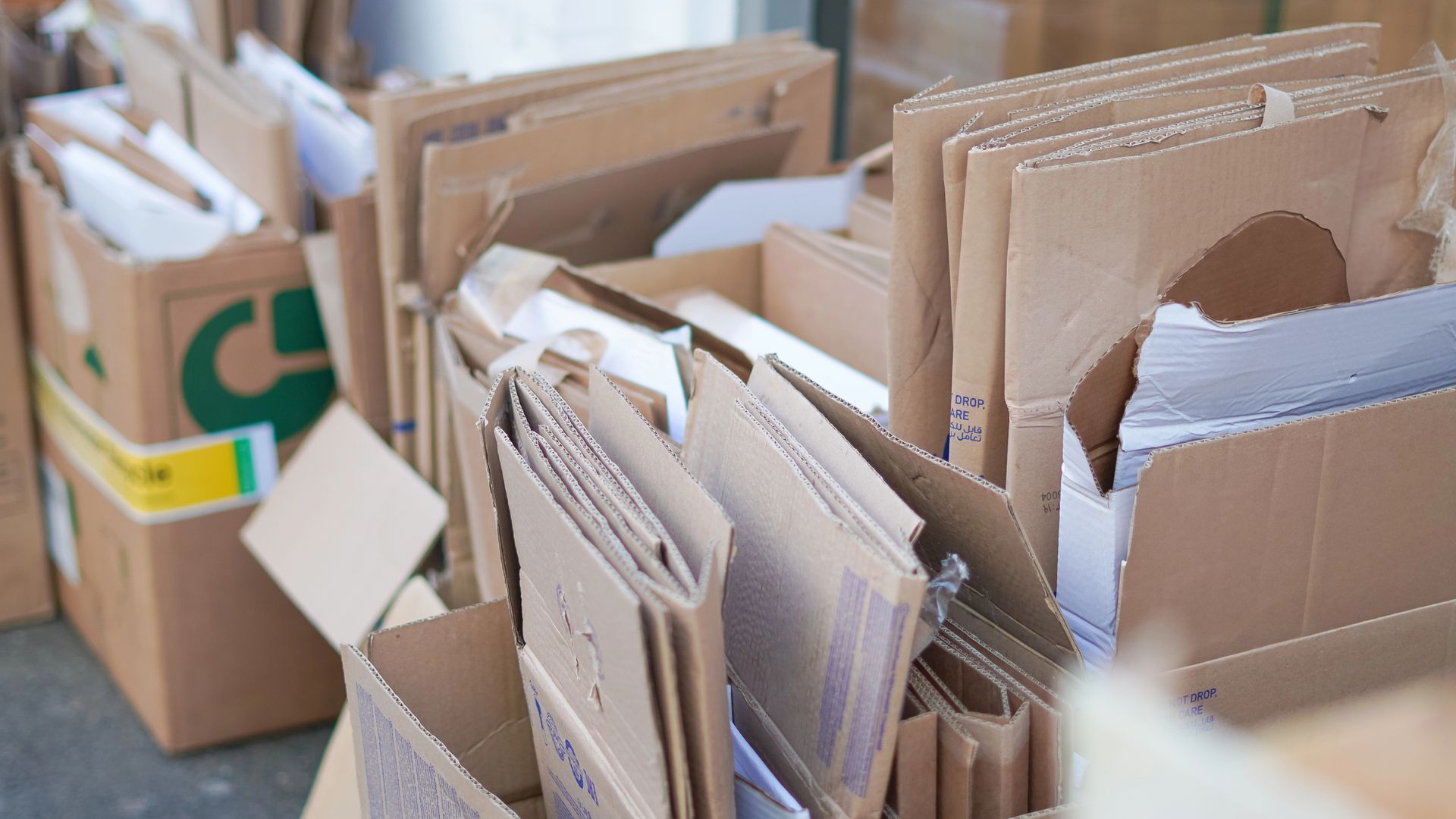 Cardboard boxes, some open, stacked; possibly for recycling.
