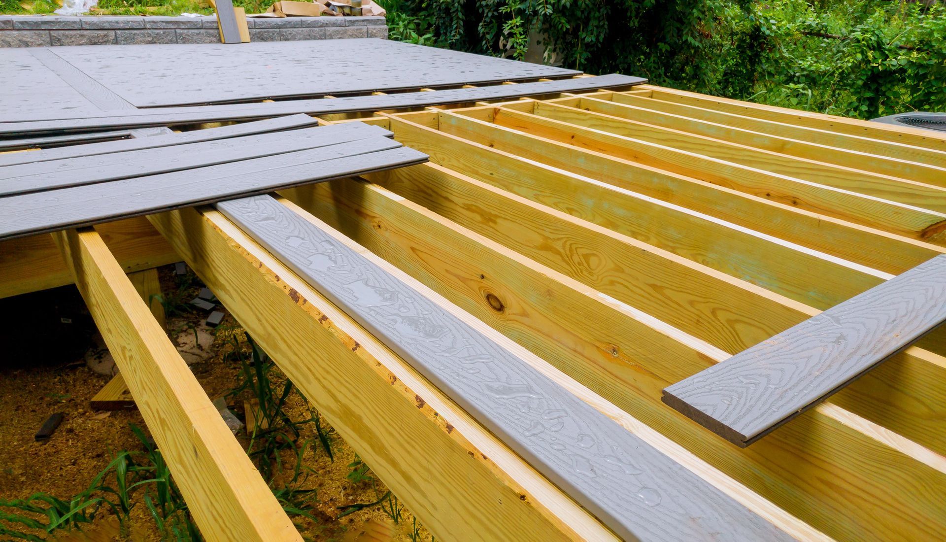 Deck frame construction with gray deck boards.