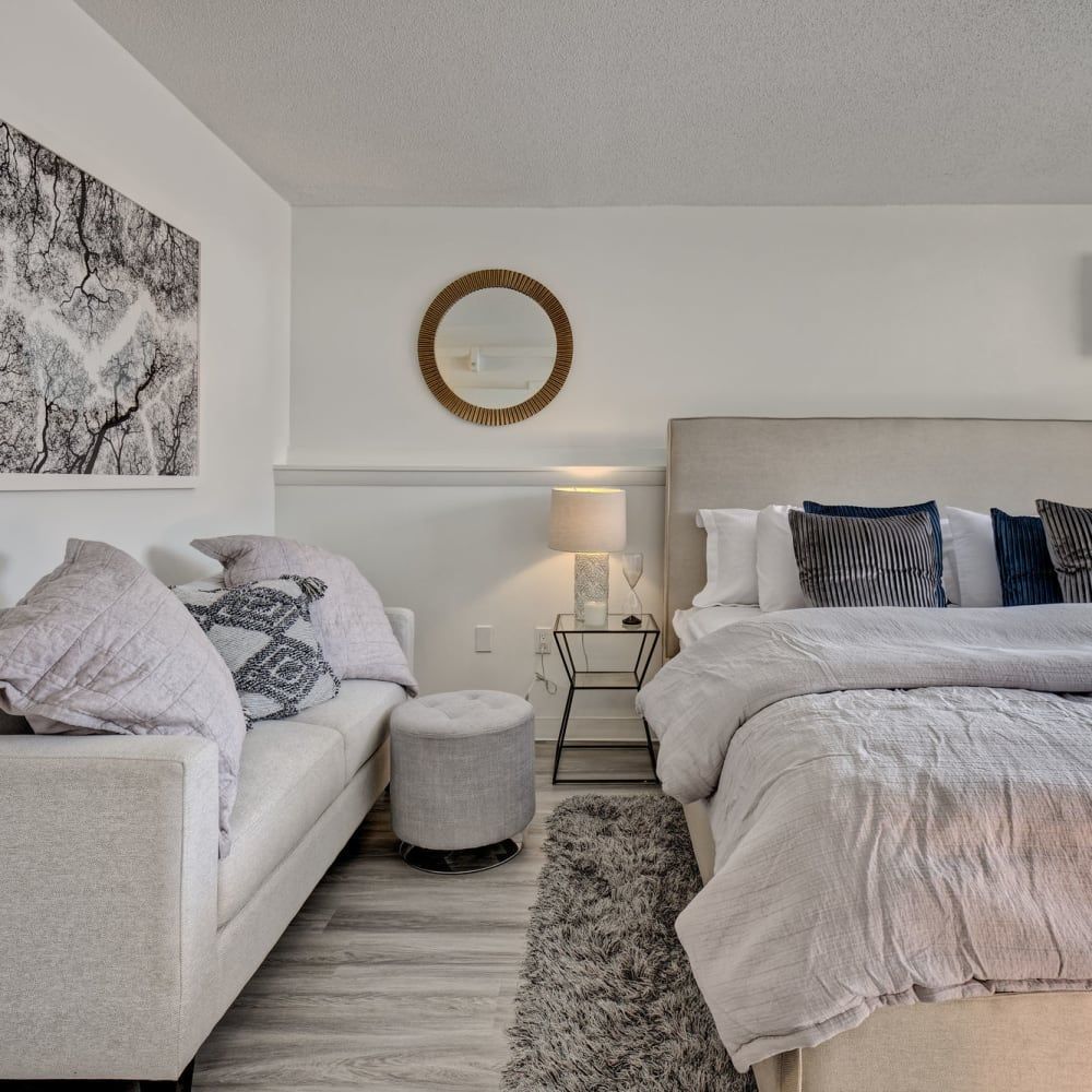 A bedroom with a large bed and a couch