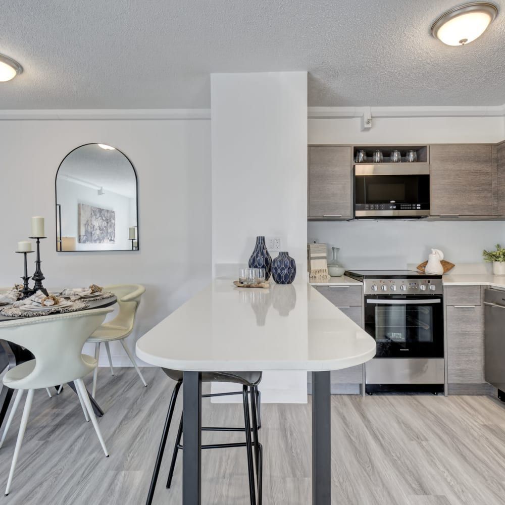 A kitchen and dining area with a table and chairs