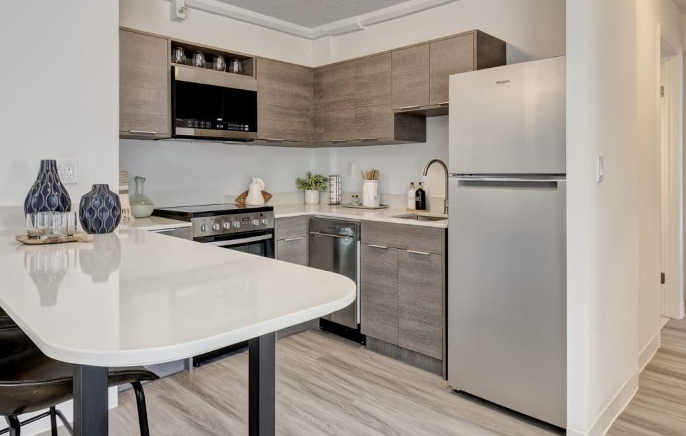 A kitchen with stainless steel appliances and wooden cabinets.