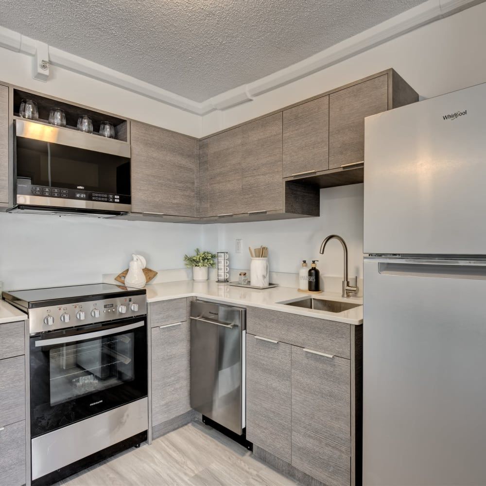 A kitchen with stainless steel appliances and wooden cabinets