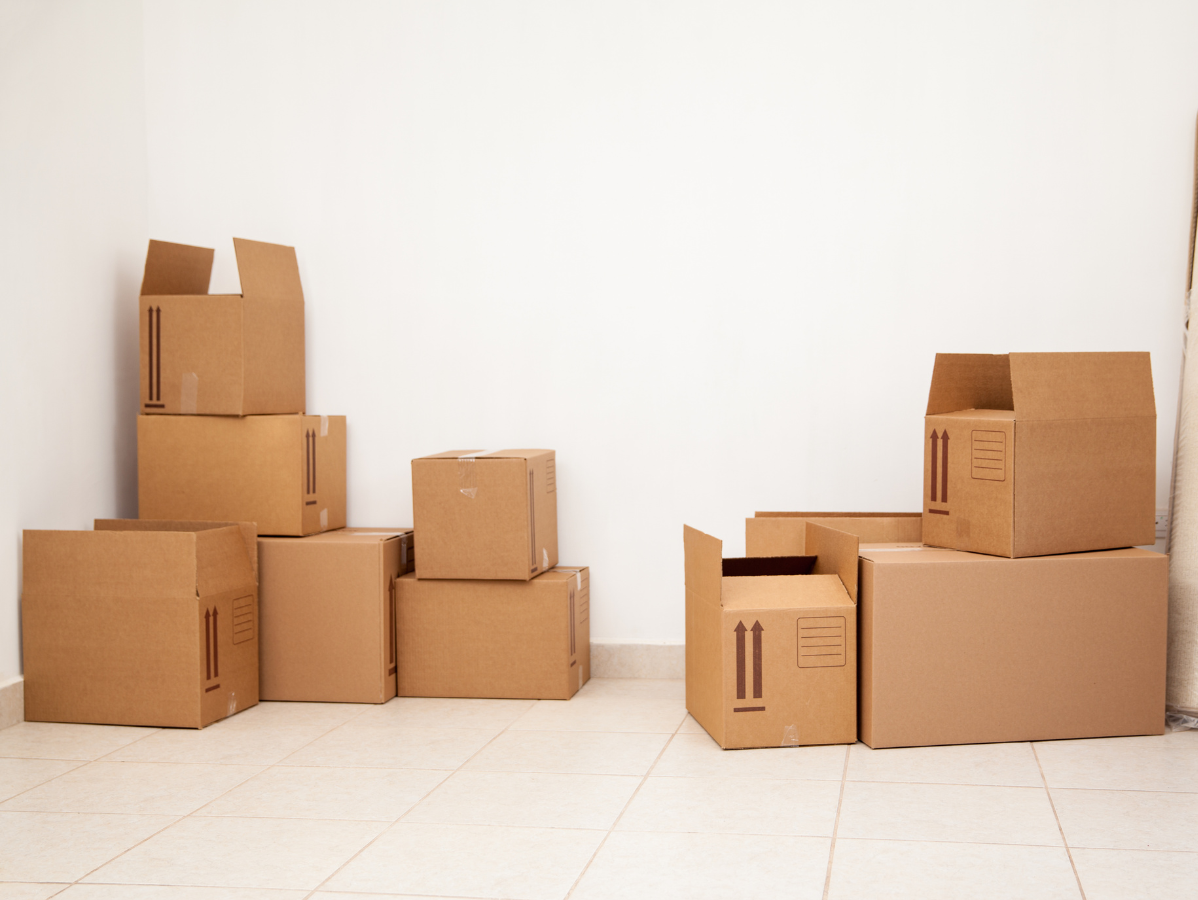 Cardboard boxes stacked in a room, preparing for a move.
