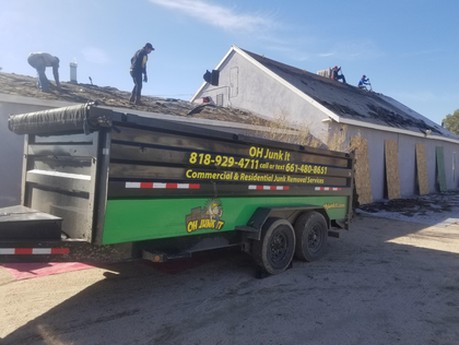 Workers on roof with trailer labeled 