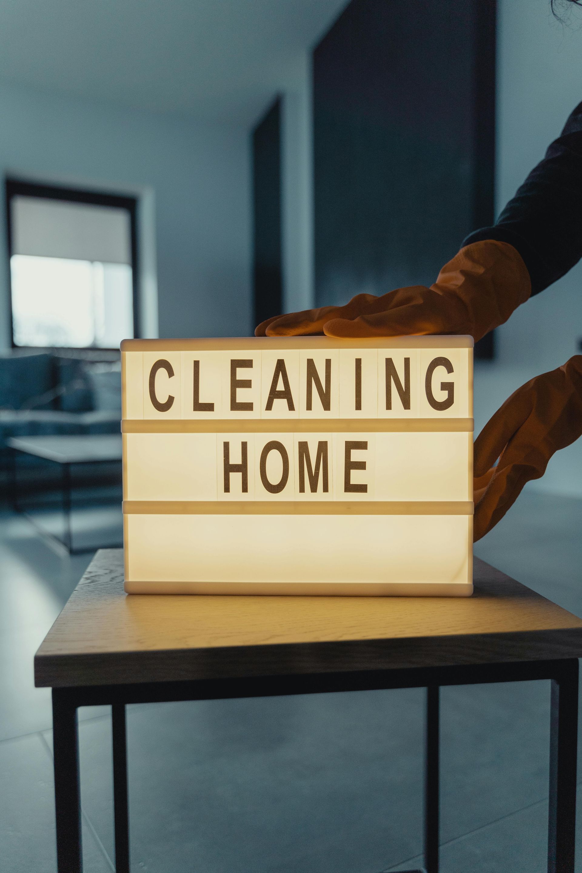 A person is cleaning a sign that says cleaning home