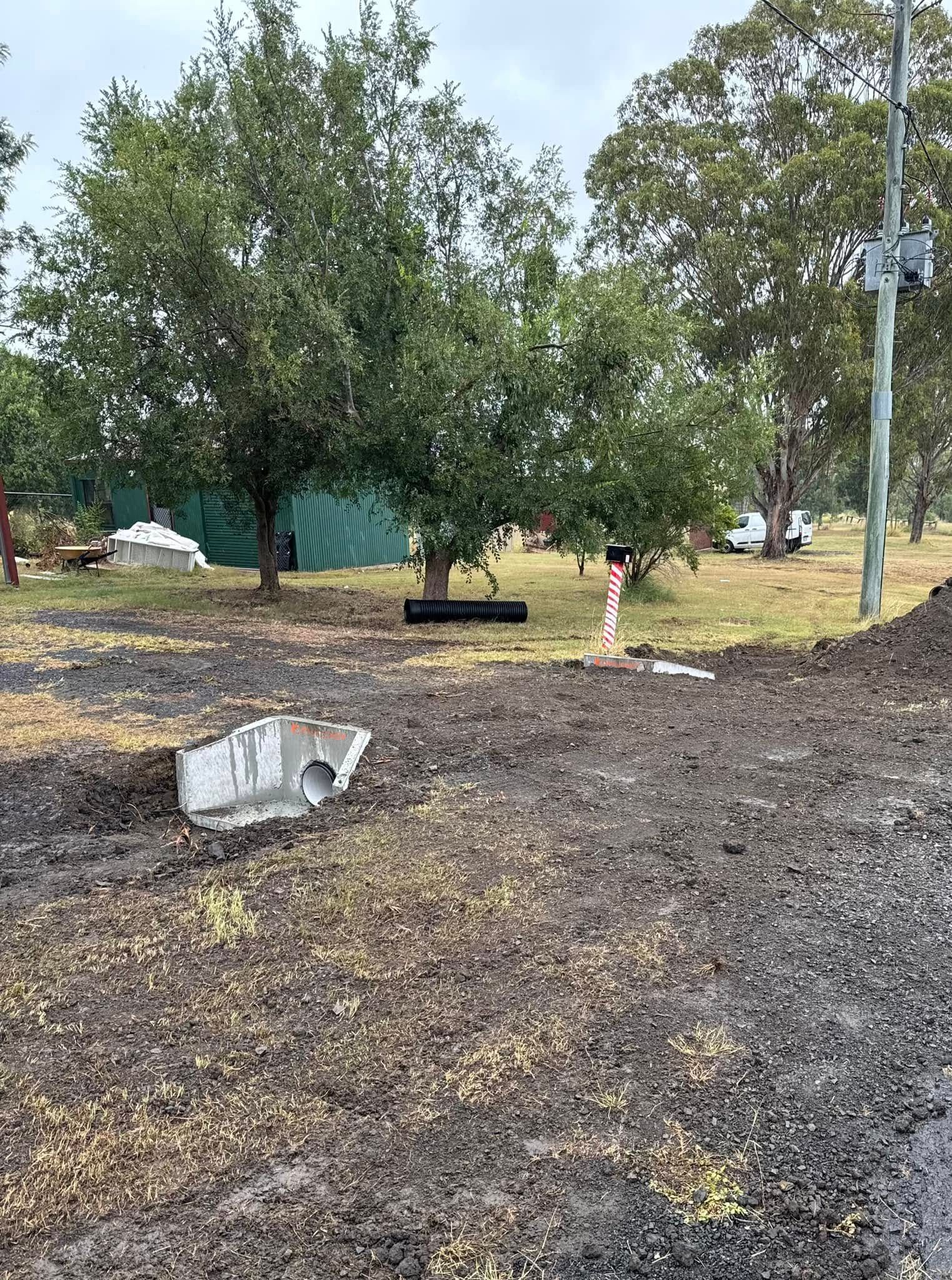 A Gravel Road Leading to a House With a Blue Sky in the Background — Ape Earthmoving In Westbrook, QLD