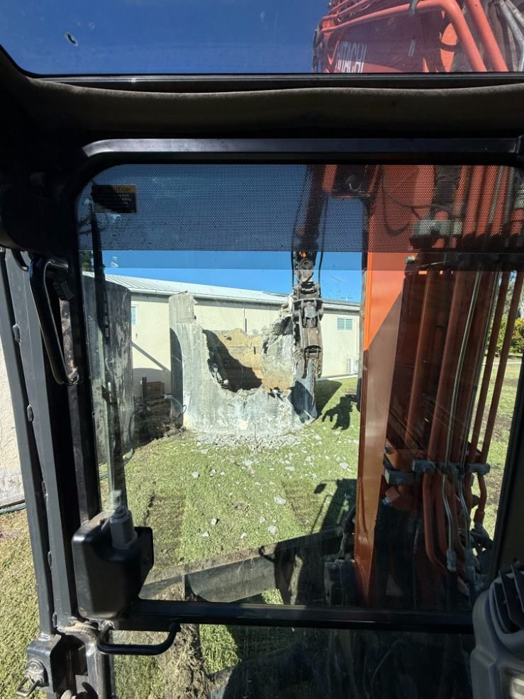 A View of an Excavator From Inside a Vehicle — Ape Earthmoving In Westbrook, QLD