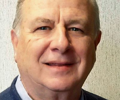 A close up of a man 's face with a smile on his face.