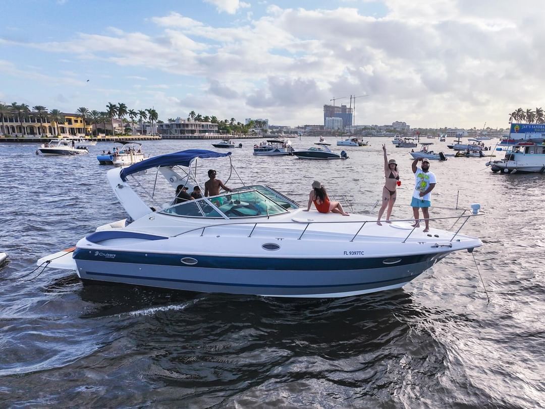 A group of people are standing on a boat in the water.
