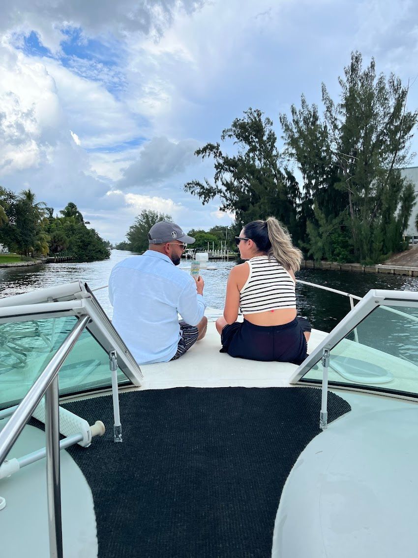 A man and a woman are sitting on the back of a boat.