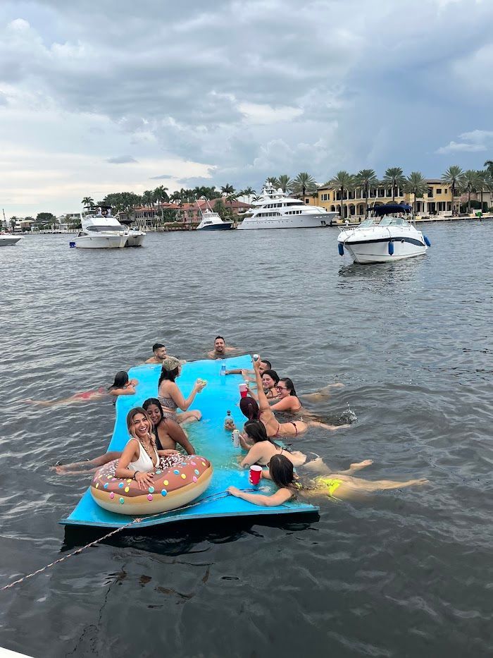 A group of people are floating on a raft in the water.