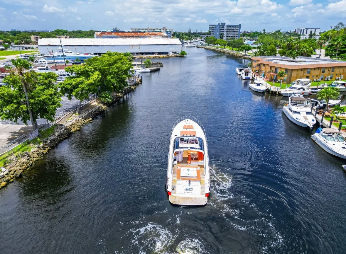 An aerial view of a boat floating down a river.