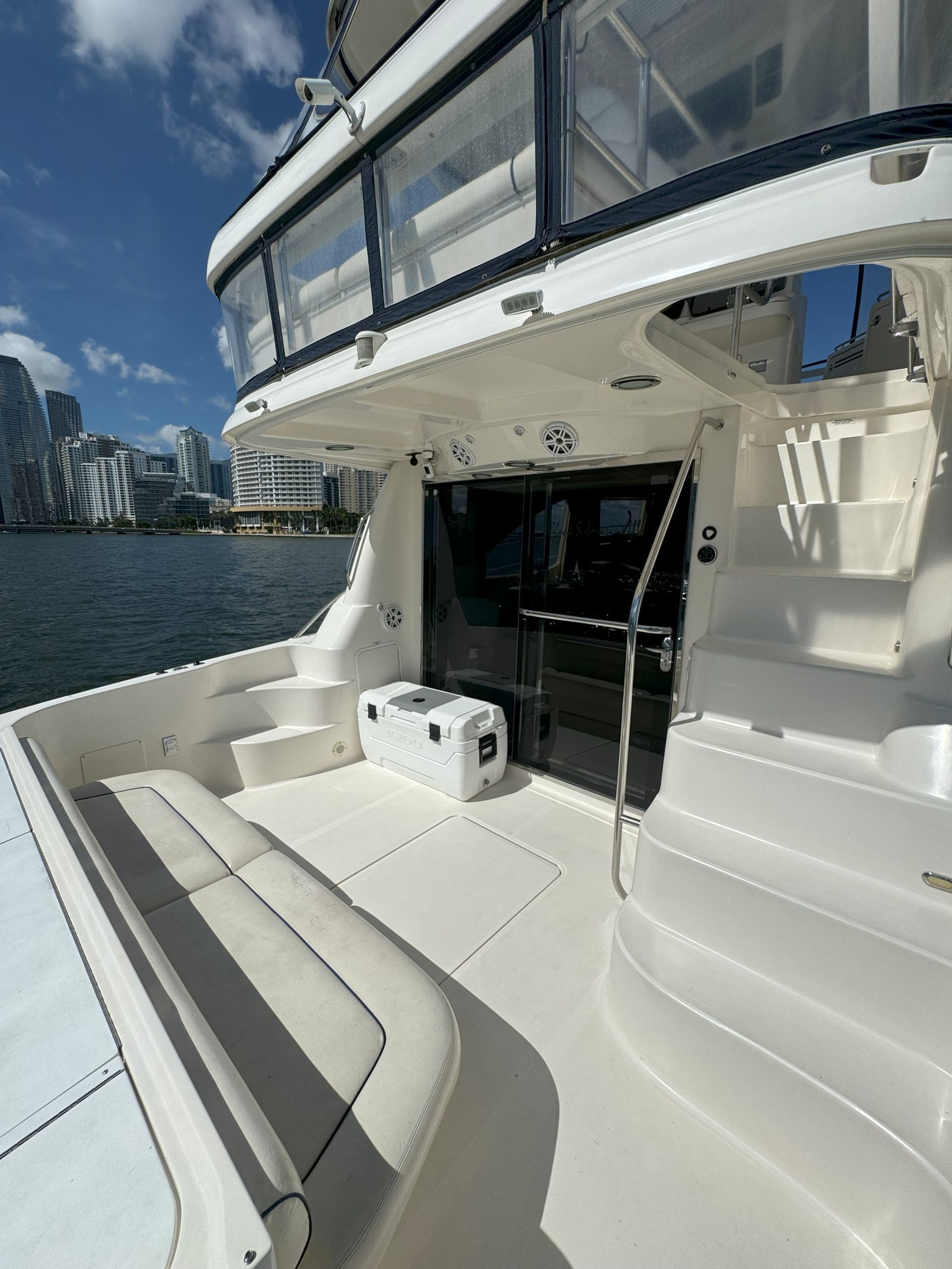 A white boat is floating on top of a body of water.