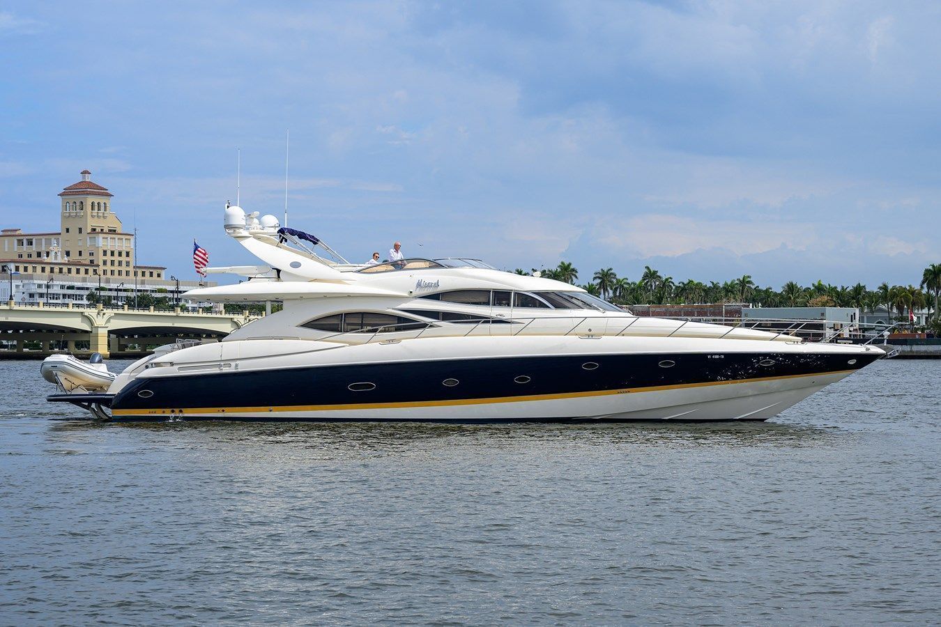 A large white yacht is floating on top of a body of water.